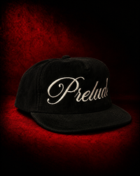 PRELUDE's black corduroy snapback hat: a textured, adjustable cap with a vintage feel. Pairs with any streetwear look. Shop PRELUDE hats.