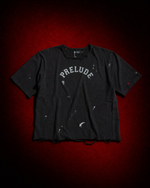 The Distressed PRELUDE Varsity T-Shirt: a worn-in, vintage-inspired tee with collegiate lettering and a lived-in finish. Shop PRELUDE streetwear.