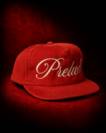 PRELUDE's red corduroy snapback hat: a textured, adjustable cap with a bold color pop and vintage feel. Shop PRELUDE hats.