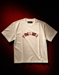 PRELUDE's white varsity t-shirt with bold red logo graphics. A classic collegiate color pairing on a clean everyday tee. Shop the varsity series.